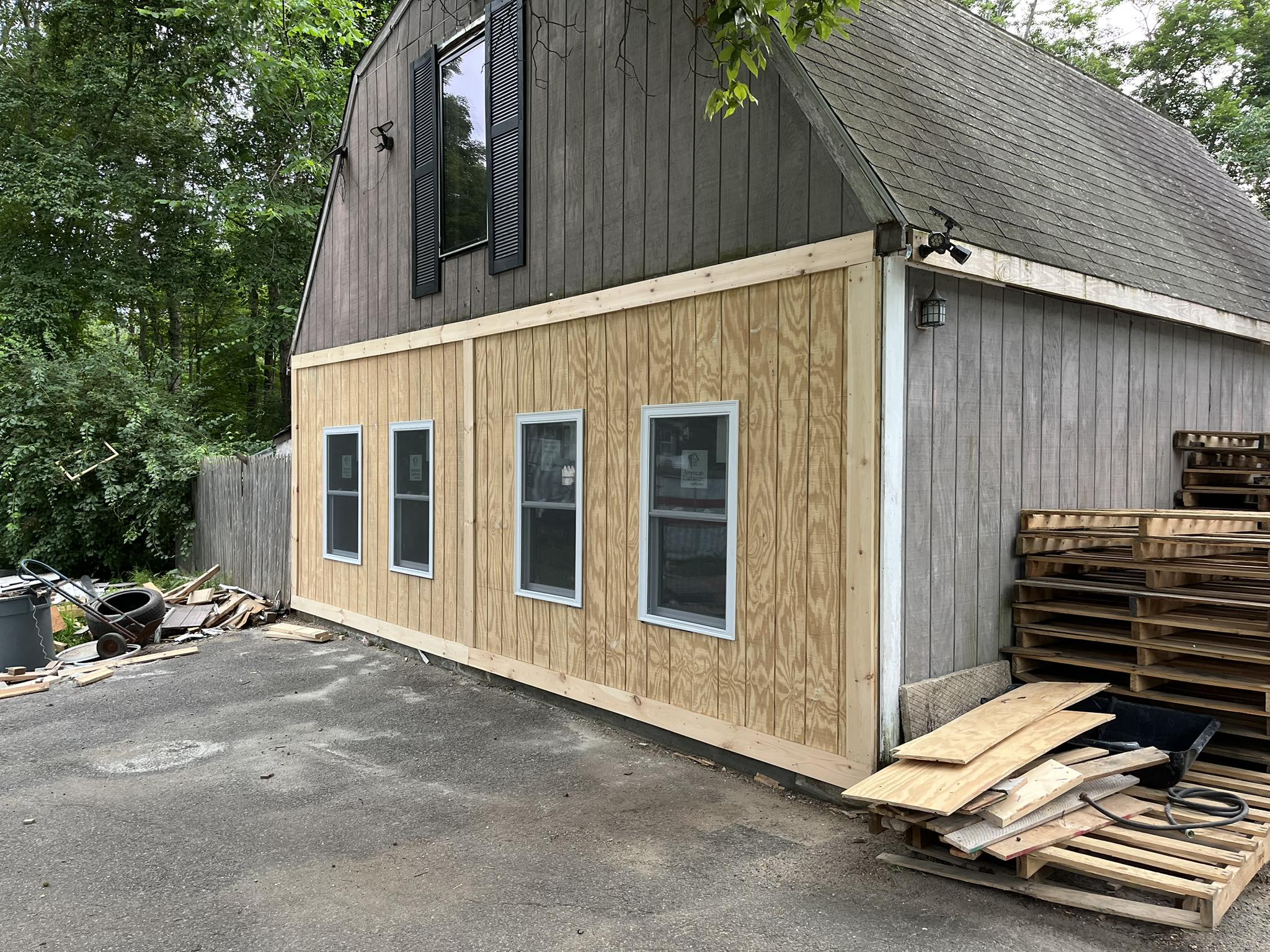 Barn exterior with new tan siding and window installation